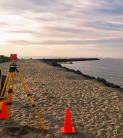 Topography surveying equipment on the beach